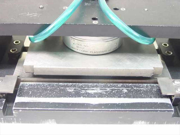Mack Corp S1014-2 Bonder Assembly – close-up of cylindrical pneumatic actuator puck with label showing P/N and Mack Corp Flagstaff AZ markings