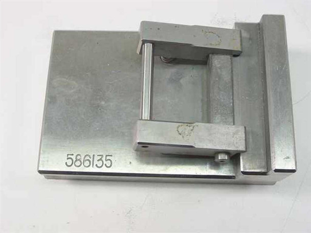 Angled top view of IC test socket jig 586135 showing U-shaped clamp bridge and spring-loaded alignment pins