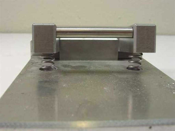 End view of IC test fixture jig showing spring-return mechanism with coil springs and cross-pin actuator rod