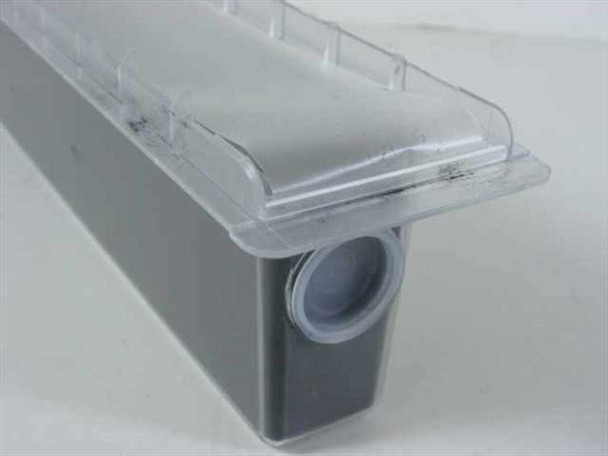 Sharp SF-720T1 black toner cartridge removed from box, seated in clear plastic protective tray — end port visible