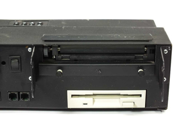 RCS ExpoLead terminal side view with thermal printer paper compartment open and 3.5-inch floppy disk drive visible