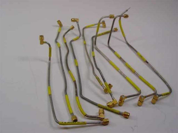 Group of semi-rigid SMA coaxial RF cables approximately 12 inches long with gold SMA connectors and yellow label sleeves, shown as example lot