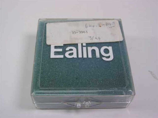 Ealing Corp 35-3961 dielectric bandpass filter in original plastic clamshell storage case, closed, with handwritten label showing part number and specs