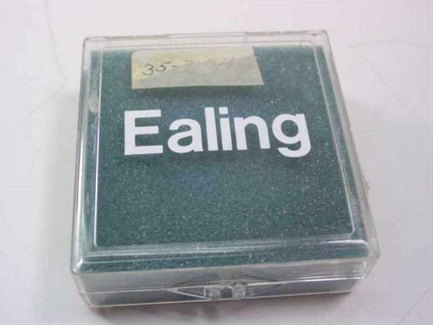 Ealing 35-3441 bandpass optical filter in original clear plastic Ealing storage case, closed — top view showing Ealing brand label and handwritten part number sticker