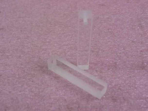 Two Hellma QX synthetic quartz open-top cuvettes with 9.9mm pathlength shown side by side at an angle on pink foam surface