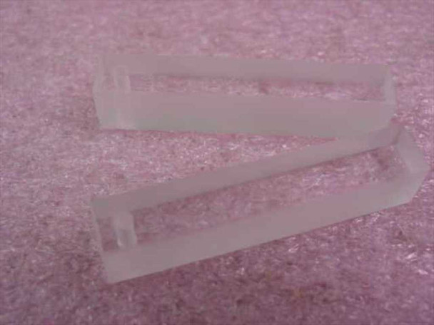 Two Hellma QX synthetic quartz cuvettes laid flat showing open-top design and transparent quartz body from above