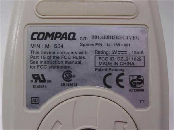 Compaq M-S34 141189-401 bottom label showing model number, spares part number, 5V 15mA rating, FCC ID DZL211029, UL and CE markings, Made in China