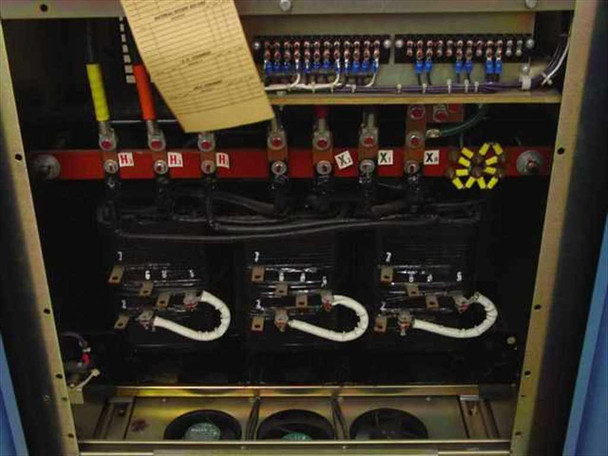 Topaz MN1C-AD075 – transformer compartment interior showing H1–H4 and X1–X2 terminal bus bars, primary and secondary winding connections, and three-phase transformer core