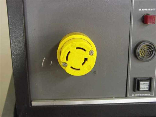 Topaz MN1C-AD075 – side panel detail showing yellow twist-lock connector (alarm/control interface) with Alarm Reset button and Silence/Enable alarm control switch