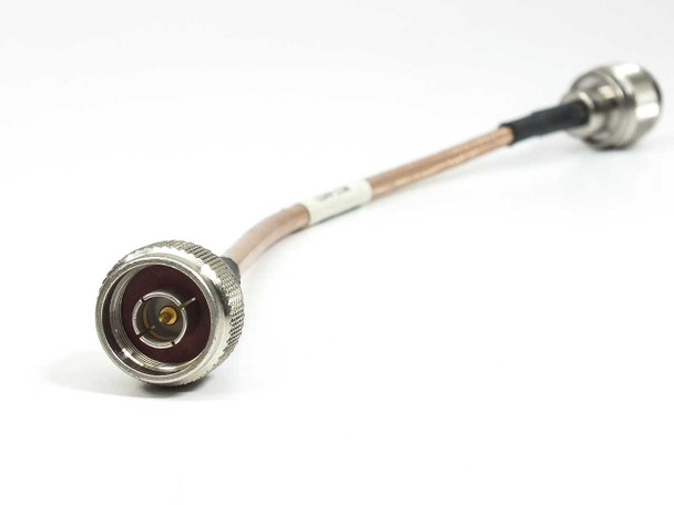 Side angle view of ESM Cable Corp RGS-400 8-inch coaxial cable showing male N-type connector face with center pin