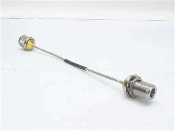Semi-rigid 0.141 coaxial cable assembly approximately 9 inches long with N-male connector on left end and N-female bulkhead connector on right end, full view