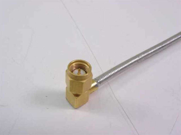KMW 200086-017 — close-up of brass SMA male right-angle connector end with semi-rigid cable jacket