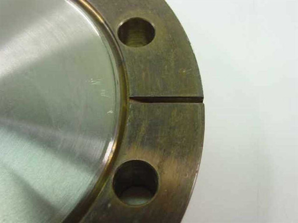 MDC vacuum flange — close-up side and top detail showing the split gap between the outer flange ring and inner disc, and hole placement