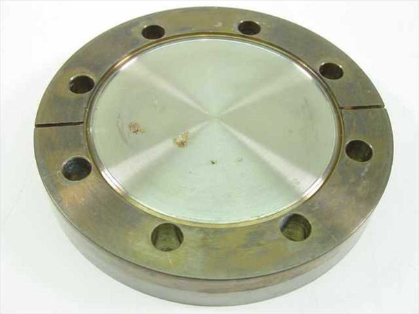 MDC vacuum blank flange 4-7/16 inch OD stainless steel — top view showing 8 mounting holes and machined center disc with surface oxidation