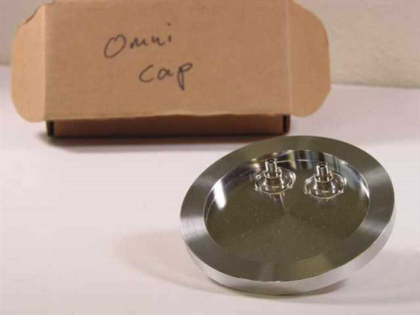 Omni Cap 101192-0027 vacuum chamber top fill port lid with original cardboard box labeled Omni Cap — angled front view showing two small feedthrough fittings on polished aluminum disk