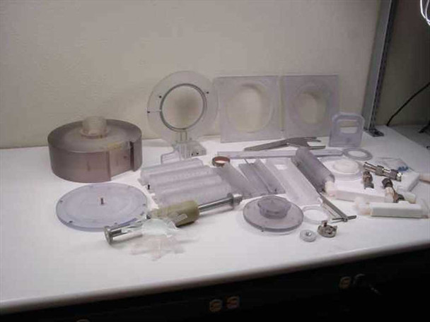 Plastic mixer parts lot — rotor bowl, round impeller disc, corrugated mixing blade assemblies, and small hardware