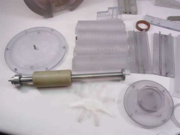 Plastic mixer rotor disc with center pin, corrugated blade stack assemblies, olive-colored roller shaft, and small impeller fan