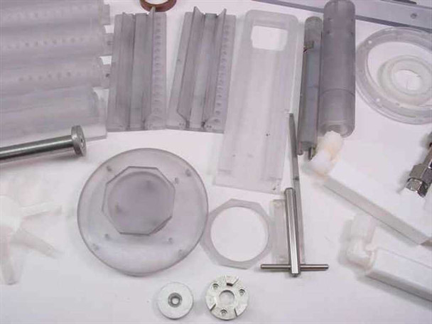 Close-up of corrugated plastic mixing blade stacks, roller shaft assembly, hexagonal plastic nut, seal ring, and small impeller fan