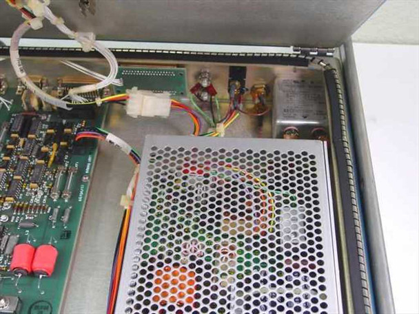 Harris TA-1023/G interior close-up showing main circuit board with components and enclosed switching power supply