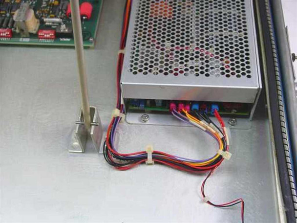 Harris TA-1023/G interior detail showing switching power supply unit and multi-connector wiring harness