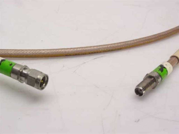 Close-up of SMA male connector (left) and SMA female connector (right) on Thermax RG400/U cable showing green strain-relief boots