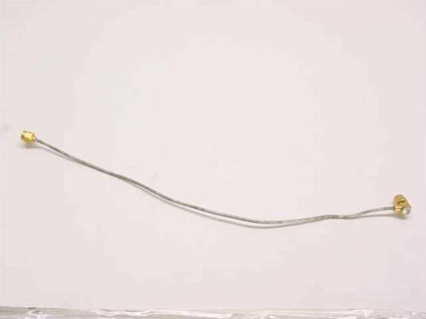 Semi-rigid flexible coaxial cable with SMA-Male straight connector on left and right-angle SMA-Male connector on right, full length view approximately 28cm