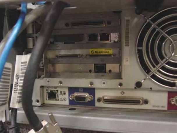 Compaq ProLiant CL1850 node I/O section showing RJ-45 network port, DB9 serial port, parallel connector, barcode label, and Do Not Use warning label on one slot