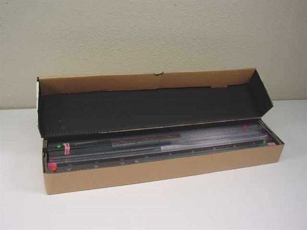 AMD AM27C2048 EPROM chips stored in anti-static rail tray inside open cardboard box — multiple units visible