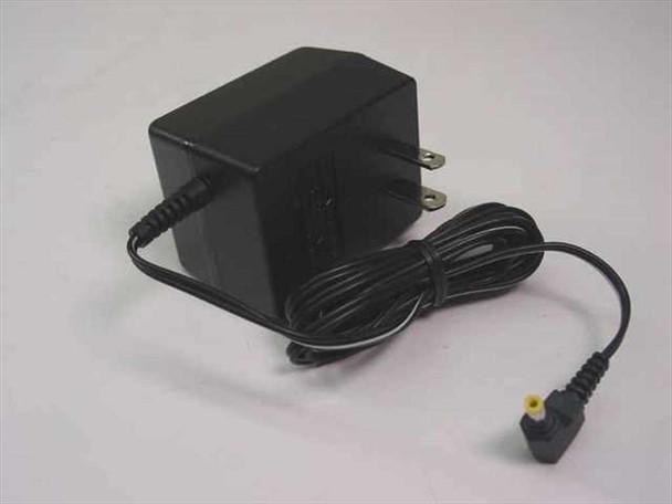 Sony AC-E455 AC power adapter – right-side view showing compact black body, folding US prongs, and output cable with barrel connector