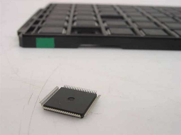 Motorola DSPE56009FJ81 DSP chip beside factory LQFP IC tray showing chip size and package