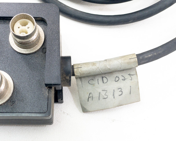 Close-up of handwritten asset tag on cable reading CID 025 A13131 near Twinax block