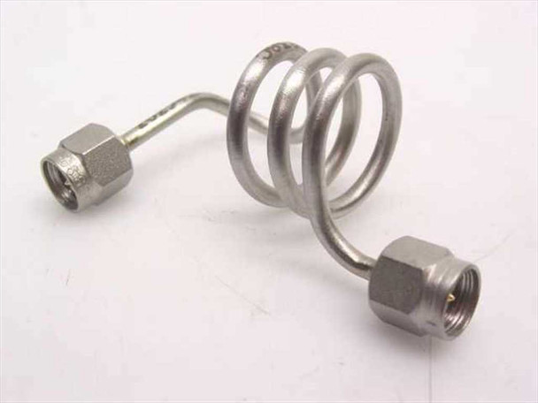 Unbranded stainless steel coiled SMA-male coaxial cable approximately 8 inches, full coil view showing both SMA-male connectors