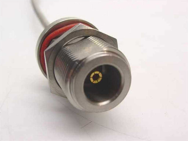 Close-up of N-Female bulkhead connector end showing stainless steel hex body, red O-ring seal, and gold center contact