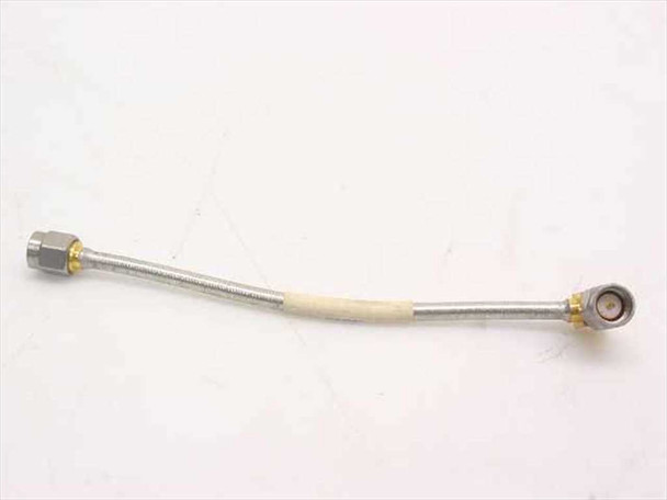 Semi-rigid coaxial RF cable approximately 4 inches long with SMA-male straight connector on left end and SMA-male right-angle connector on right end — full side view