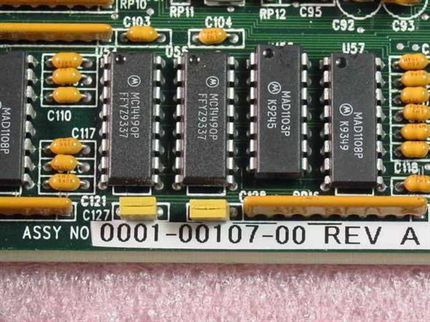 IVS 0001-00107-00 Rev A assembly number label close-up showing MC14490P and MAD1103P ICs with board silk-screen markings
