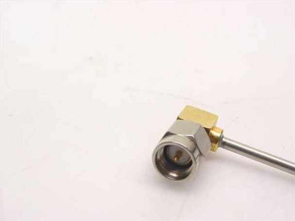 Close-up of the right-angle SMA male connector end with gold-plated body and stainless steel cable entry