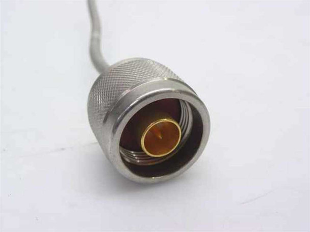 Close-up of N-type female bulkhead connector end of semi-rigid coaxial cable showing knurled metal body and center pin