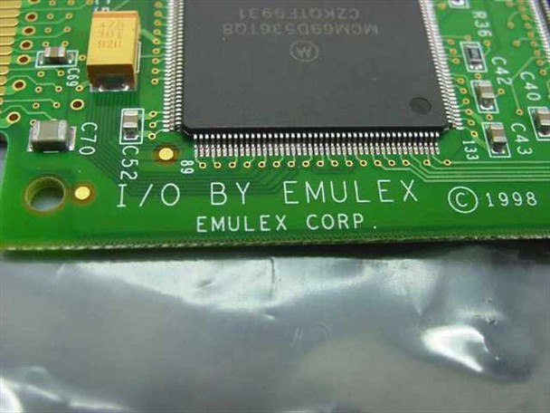Emulex FC1020017-07B PCB closeup — 'I/O BY EMULEX EMULEX CORP © 1998' silkscreen and Motorola MCM69D536TQ8 main controller chip
