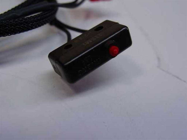 Ultratech Stepper 01-08-00081 Reticle Slider Home Sensor — angled view of small black microswitch body with red LED indicator and braided cable
