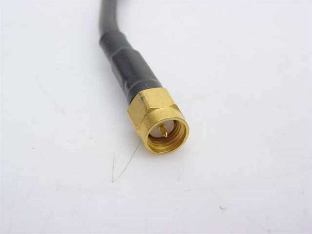 Close-up of gold SMA male connector end of RG-58 coaxial cable showing threaded body and center pin