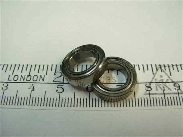 Steel double-shielded ball bearing 3/8 x 5/8 x 5/32 shown next to ruler for scale – top view of two bearings