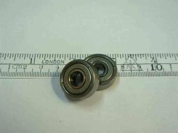 627-2Z double shielded steel ball bearing 7x22x7mm shown alongside metric ruler for scale — two bearings visible