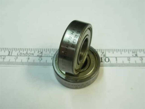 6200-2Z ball bearings stacked at an angle next to ruler, showing shielded outer race and 6200-2Z markings on race