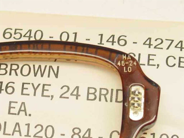 Close-up of USS 6540-01-146-4274 spectacle front bridge showing HA 46-24 LO size markings and metal hinge hardware