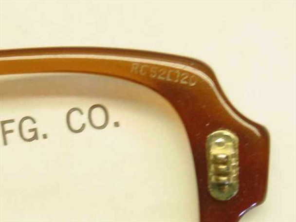 Close-up of US Military spectacle frame temple hinge showing RC 52/20 size marking and Rochester Optical stamp