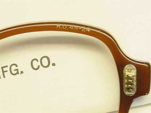 Close-up of Rochester Optical spectacle frame bridge showing stamped R.O. 48-24 size marking and hinge detail