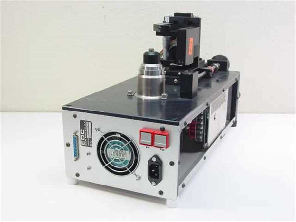 EDC 551A-DTS-05 Disk Test Fixture – left rear three-quarter view showing cooling fan, IEC AC inlet, red power switches, and spindle/lens assembly on top
