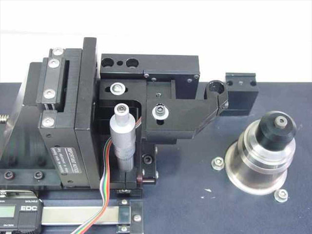 EDC 551A-DTS-05 spindle and linear slide mechanism closeup – showing PMI Kollmorgen spindle motor, precision positioning arm, slide rail, and optical/lens assembly
