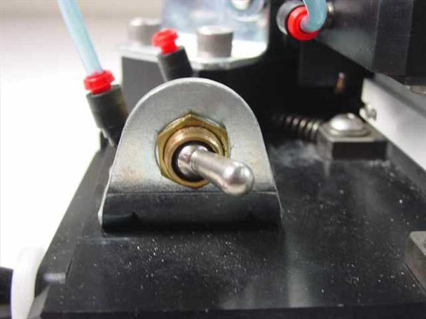 Close-up of linear bearing mount on aluminum base plate showing brass bushing and bearing shaft