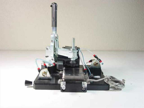 Custom vacuum chuck assembly front-left view showing toggle clamp arm, pneumatic tubing, linear bearing, and aluminum base plate